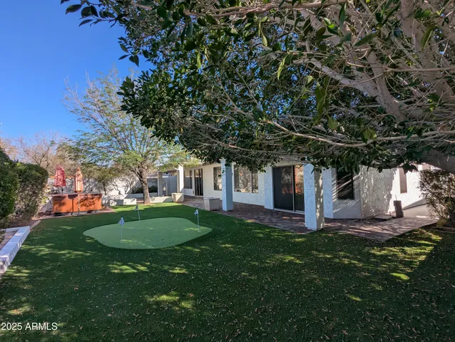 a view of a backyard with sitting area