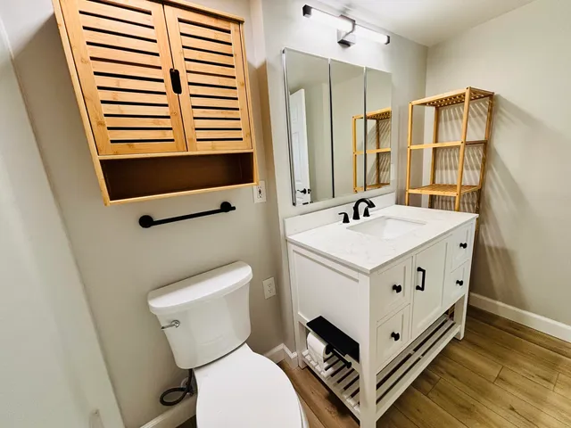 a bathroom with a sink toilet and shower