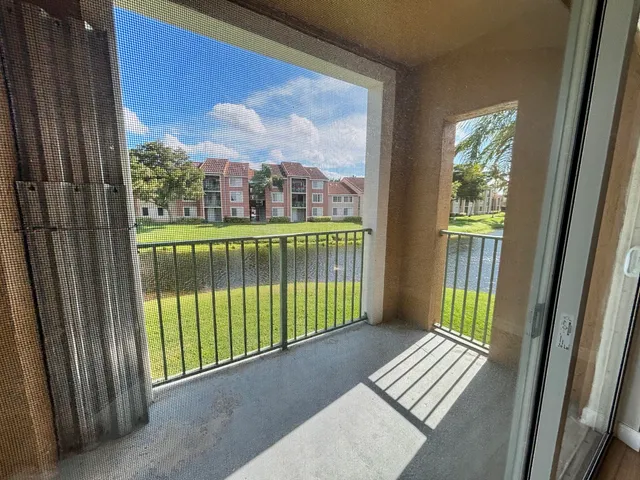 a view of a room with wooden floor and a window