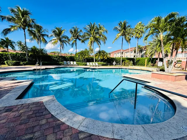 swimming pool view with a garden