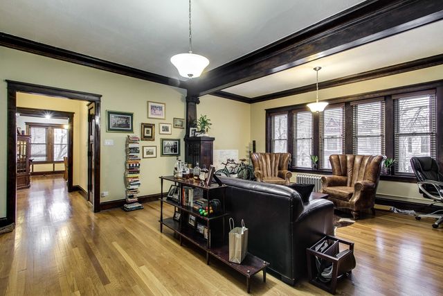 a view of a livingroom with furniture hardwood floor and a window