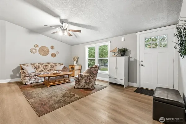 a living room with furniture and wooden floor