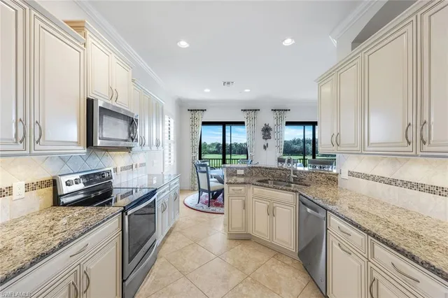 a kitchen with a sink stove and cabinets