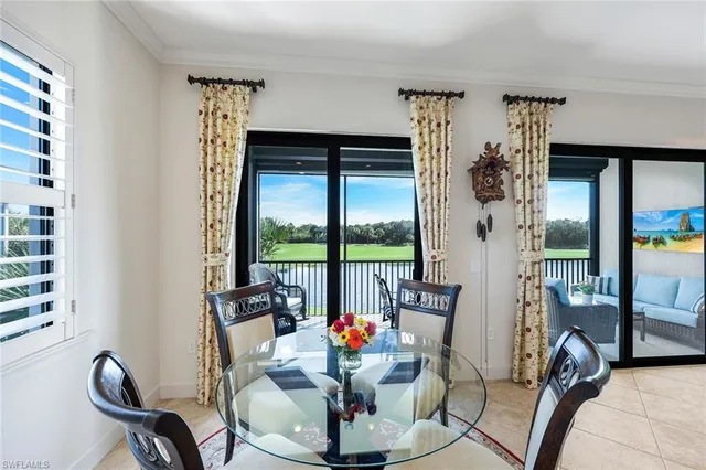 a view of a dining room with furniture large windows and wooden floor