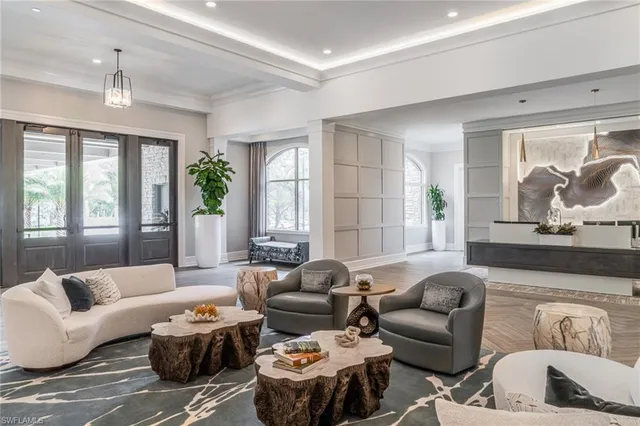 a living room with furniture and large windows