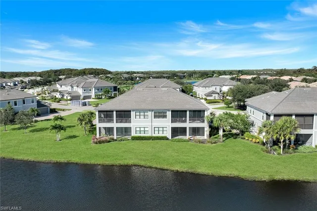 a view of a house with a big yard and large trees