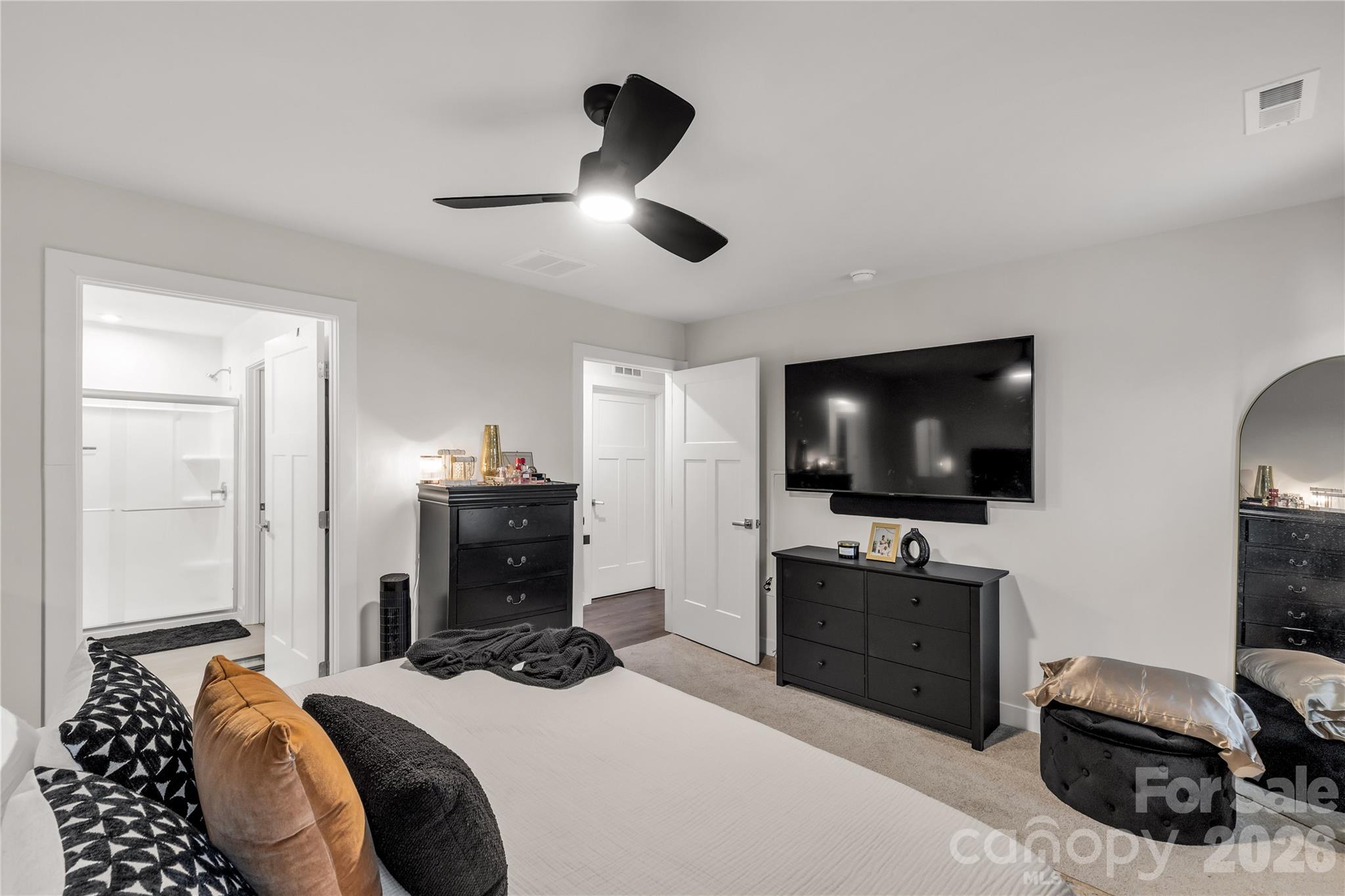 810 Purslane Street Lancaster, SC 29720 - Photo 16 of 24 a bedroom with a bed and a flat tv screen on wall