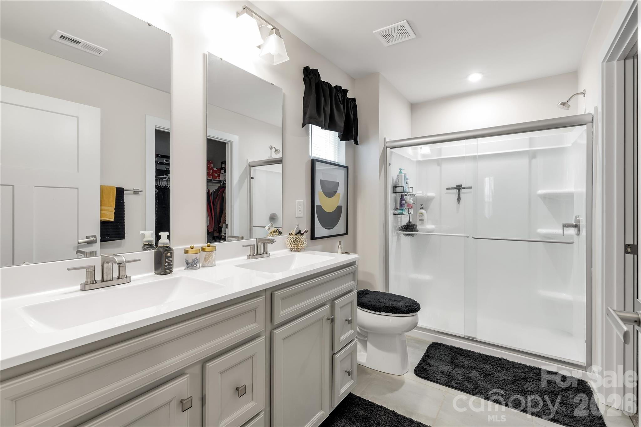 810 Purslane Street Lancaster, SC 29720 - Photo 17 of 24 a bathroom with a double vanity sink toilet and shower