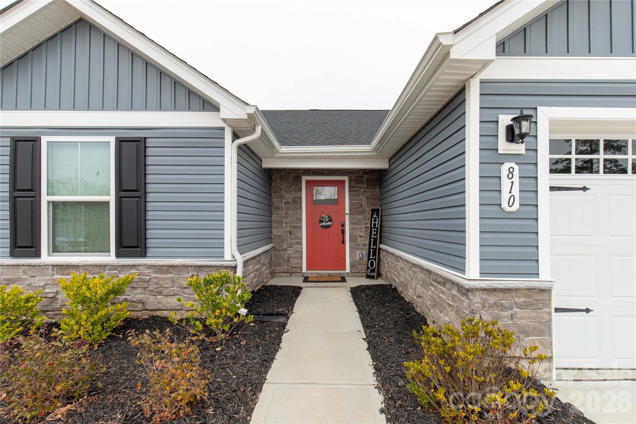 810 Purslane Street Lancaster, SC 29720 - Photo 2 of 24 a front view of a house with lots of flowers