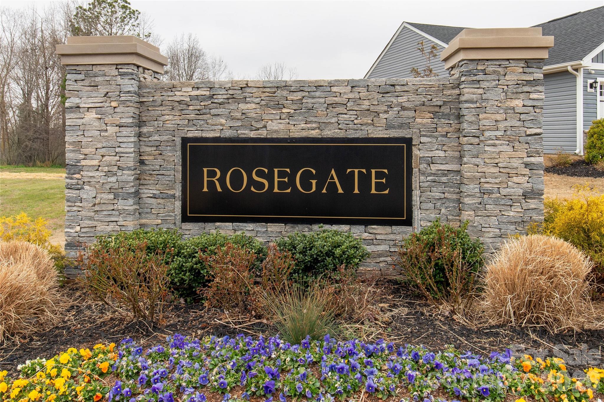 810 Purslane Street Lancaster, SC 29720 - Photo 24 of 24 a sign broad in front of flowers
