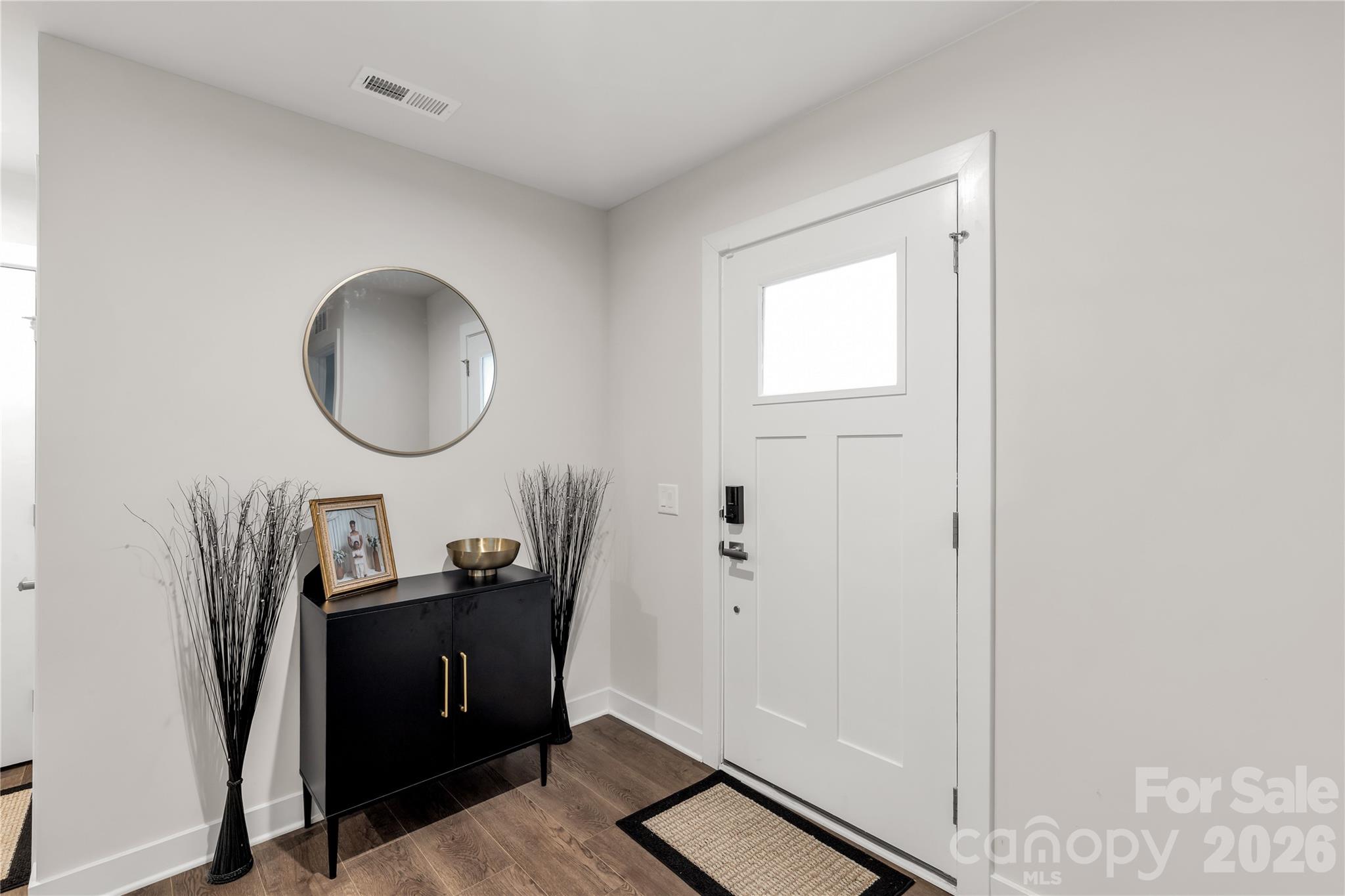 810 Purslane Street Lancaster, SC 29720 - Photo 3 of 24 a very nice looking room with a mirror and a wooden floor