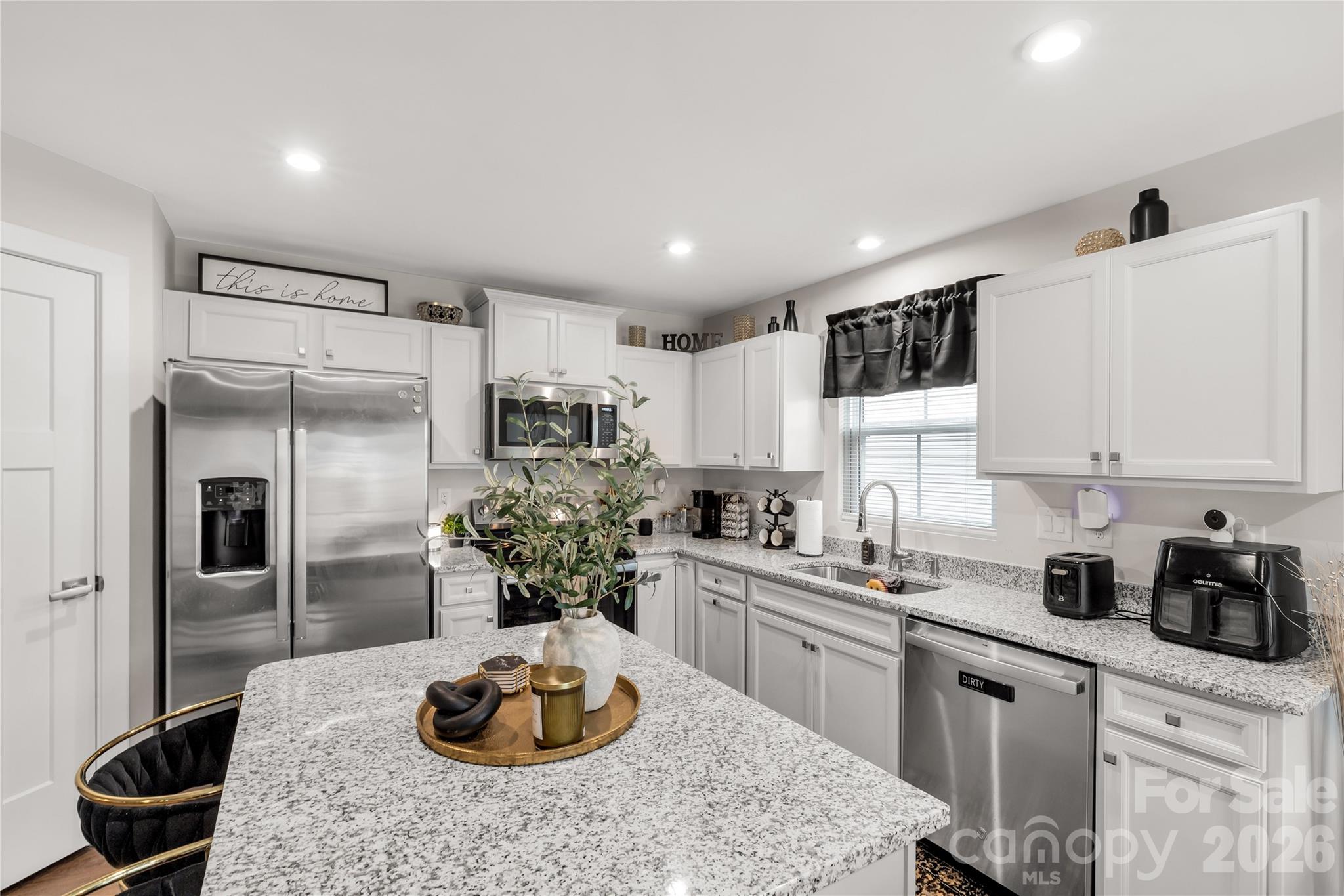 810 Purslane Street Lancaster, SC 29720 - Photo 9 of 24 a kitchen with a refrigerator and cabinets