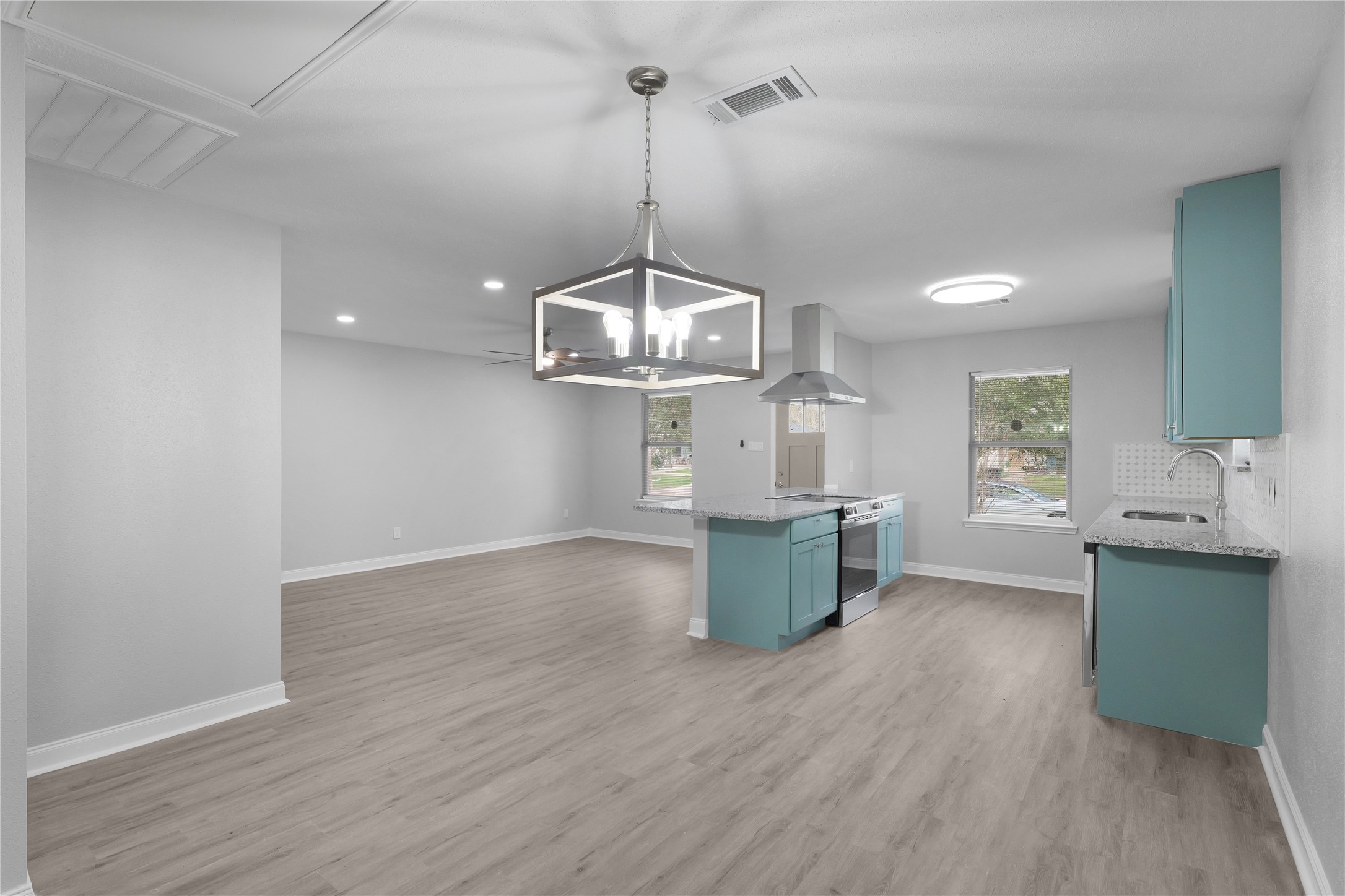 9827 Shive Drive Houston, TX 77078 - Photo 6 of 15 a kitchen with kitchen island a wooden floor and a view of living room
