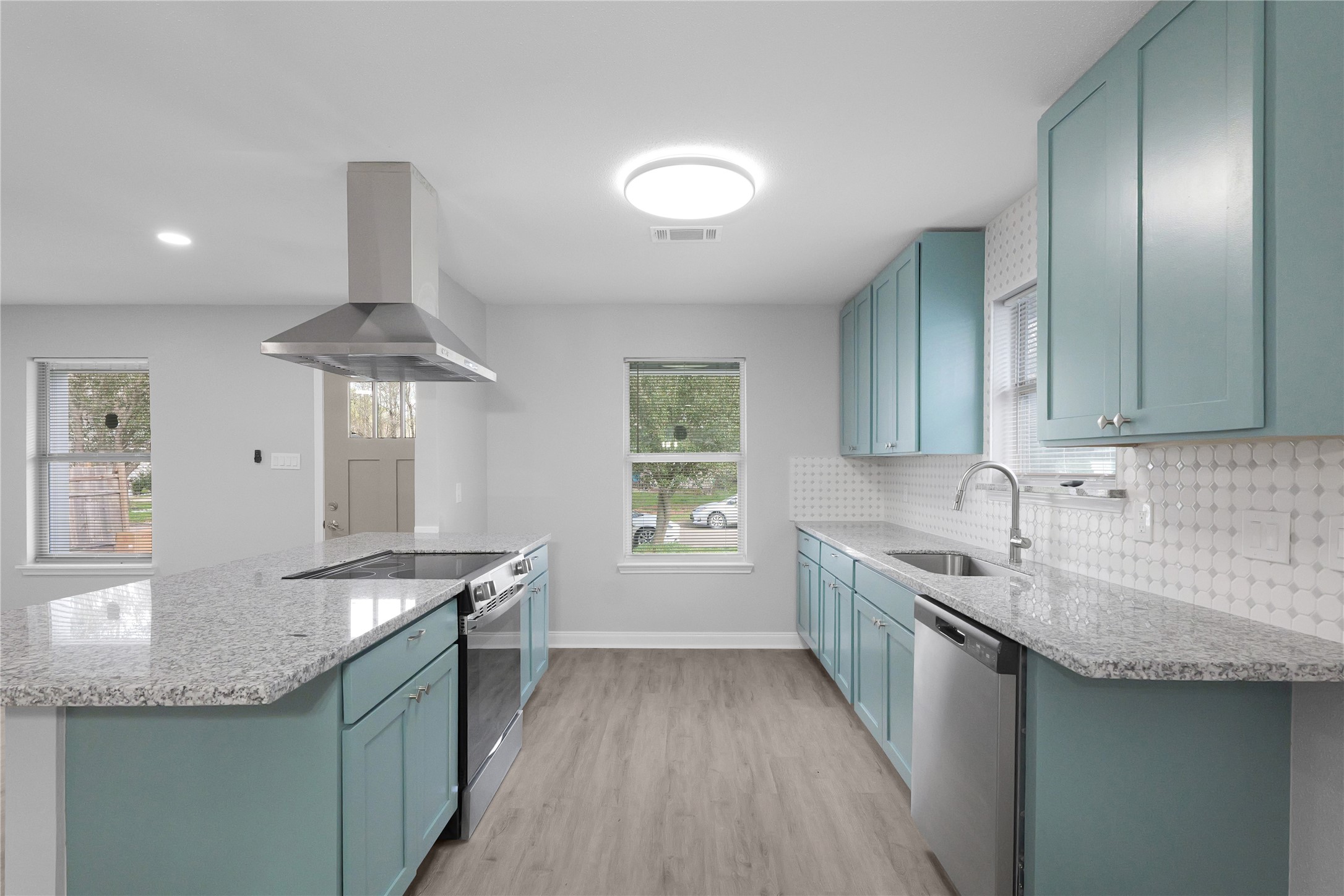 9827 Shive Drive Houston, TX 77078 - Photo 8 of 15 a kitchen with granite countertop stainless steel appliances a sink stove and cabinets