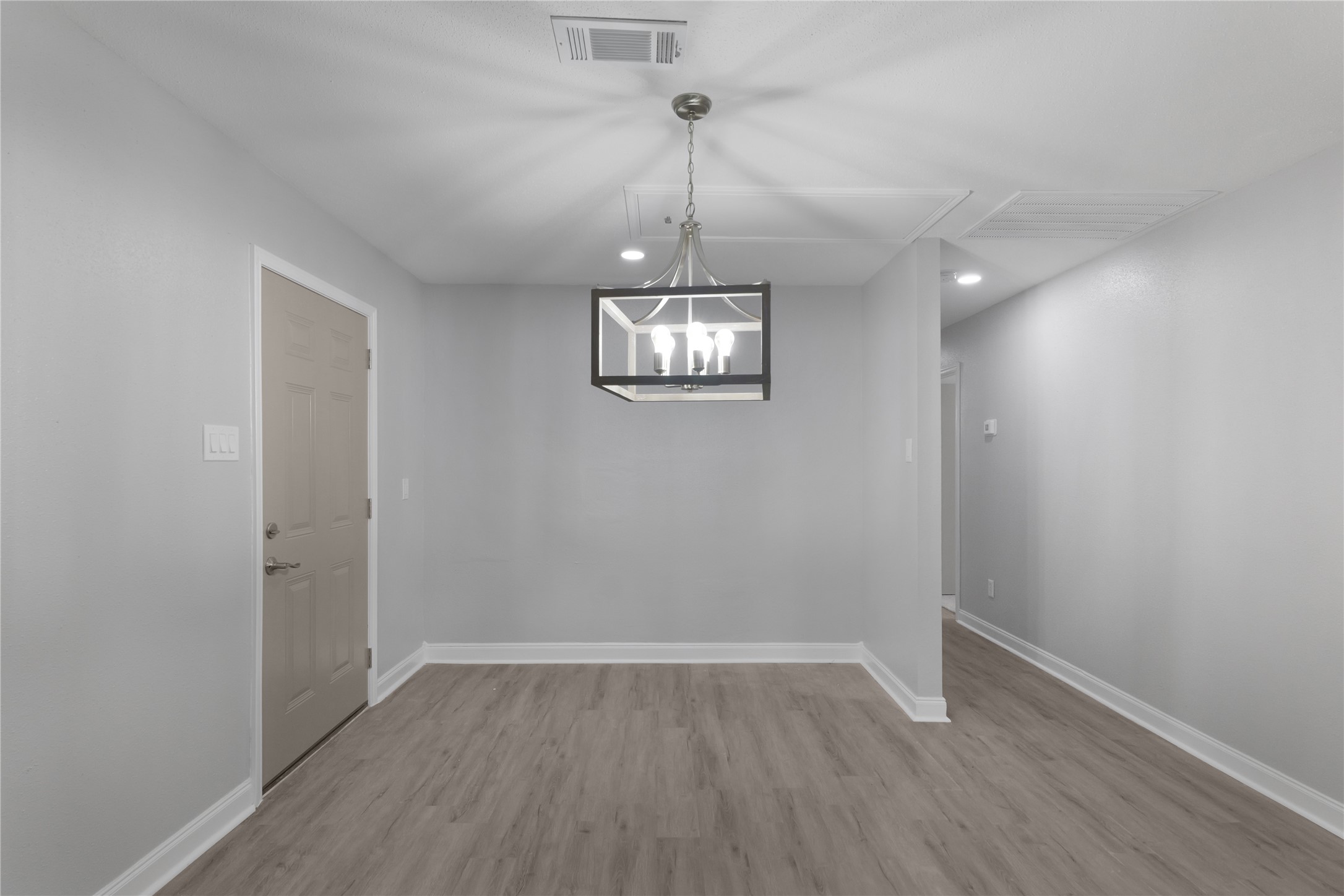 9827 Shive Drive Houston, TX 77078 - Photo 9 of 15 a view of a room with wooden floor chandelier and window