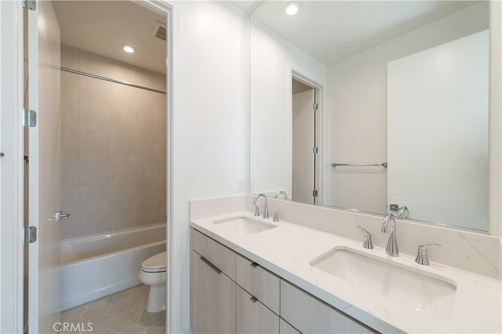 2604 Everly Drive San Diego, CA 92108 - Photo 19 of 33 a bathroom with a bathtub shower sink vanity and toilet