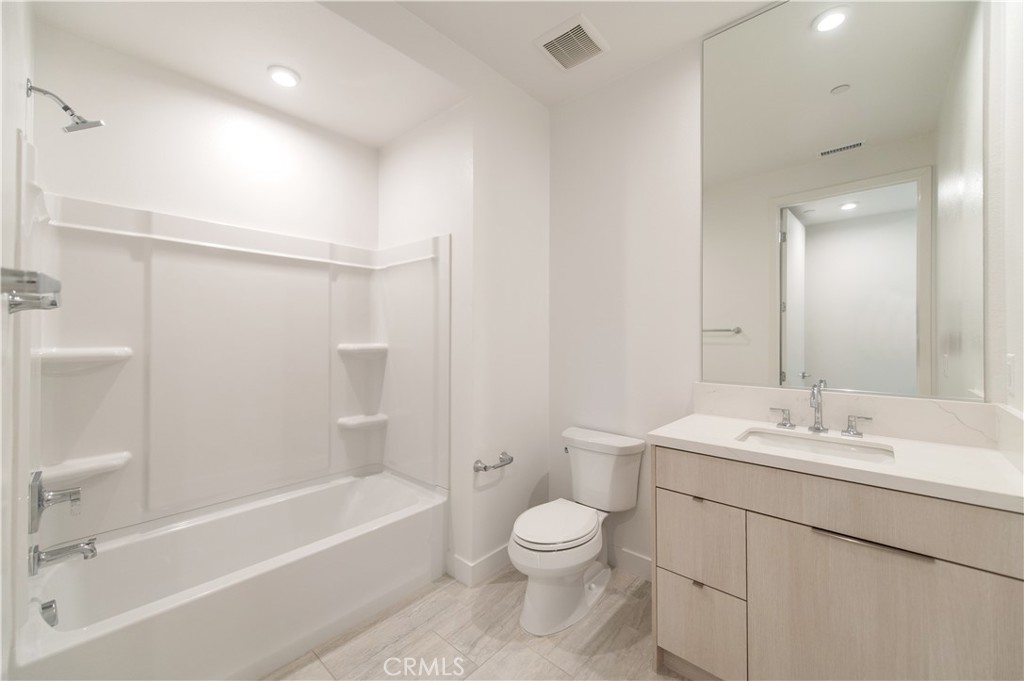 2604 Everly Drive San Diego, CA 92108 - Photo 28 of 33 a bathroom with a bathtub shower sink vanity mirror and toilet