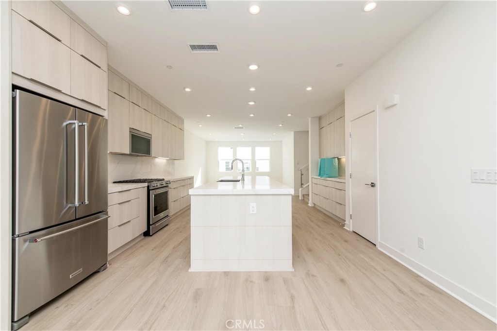 2604 Everly Drive San Diego, CA 92108 - Photo 6 of 33 a kitchen with a refrigerator and a stove top oven