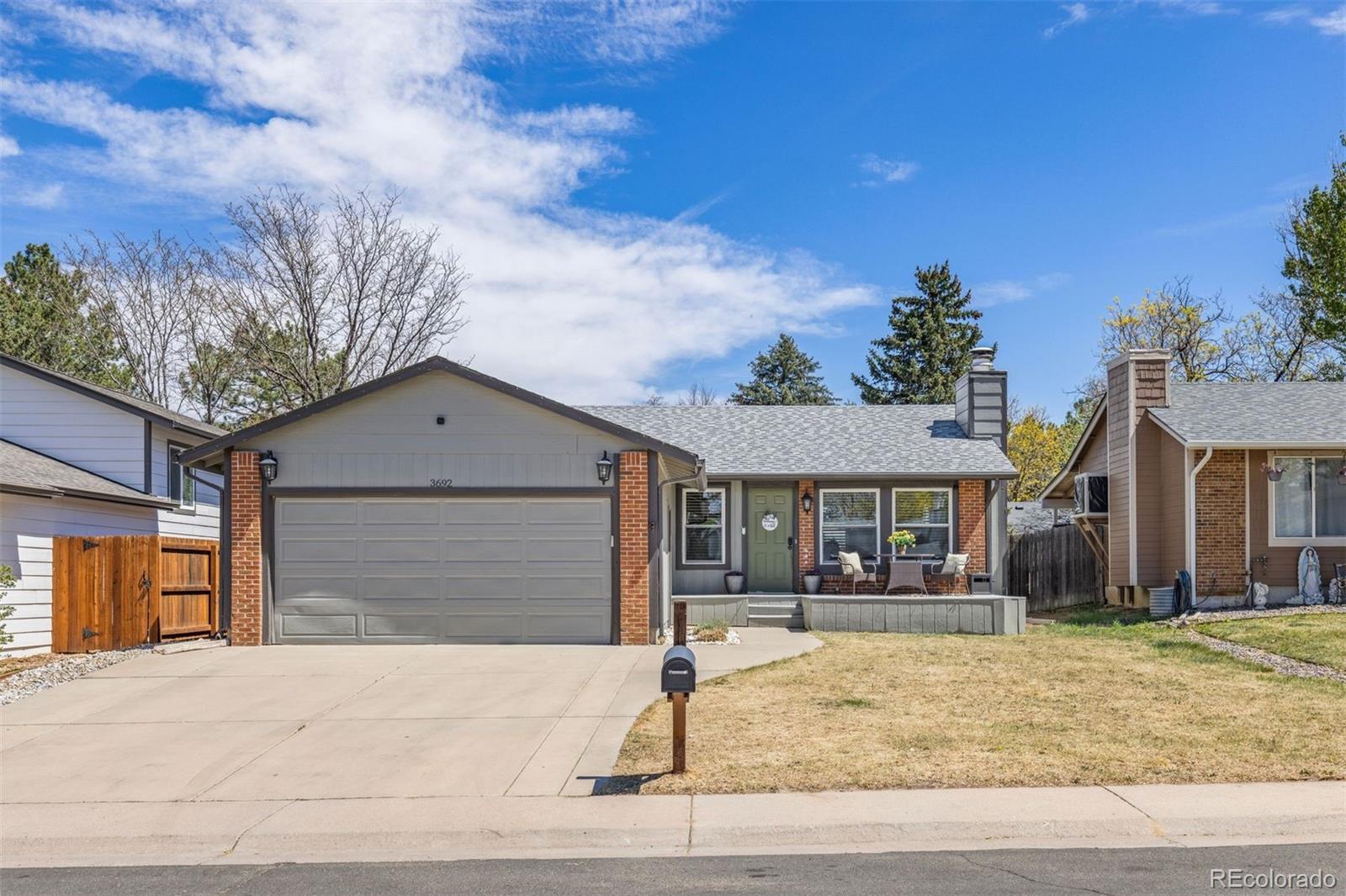 3692 South Mobile Way Aurora, CO 80013 - Photo 1 of 48 a front view of a house with garden