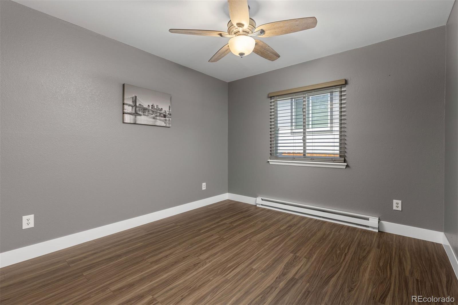 3692 South Mobile Way Aurora, CO 80013 - Photo 20 of 48 wooden floor in an empty room with a window