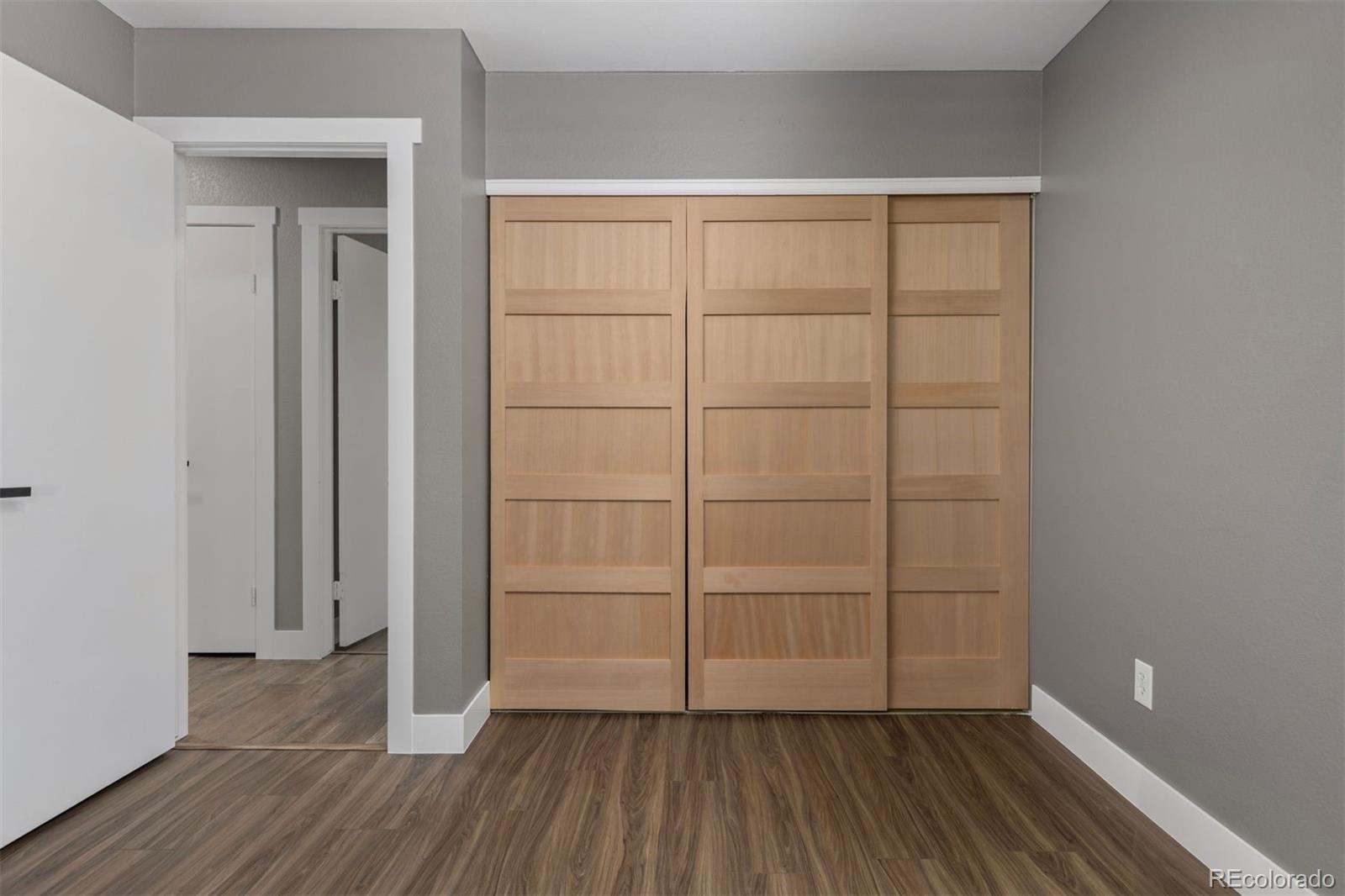 3692 South Mobile Way Aurora, CO 80013 - Photo 21 of 48 an empty room with wooden floor and closet