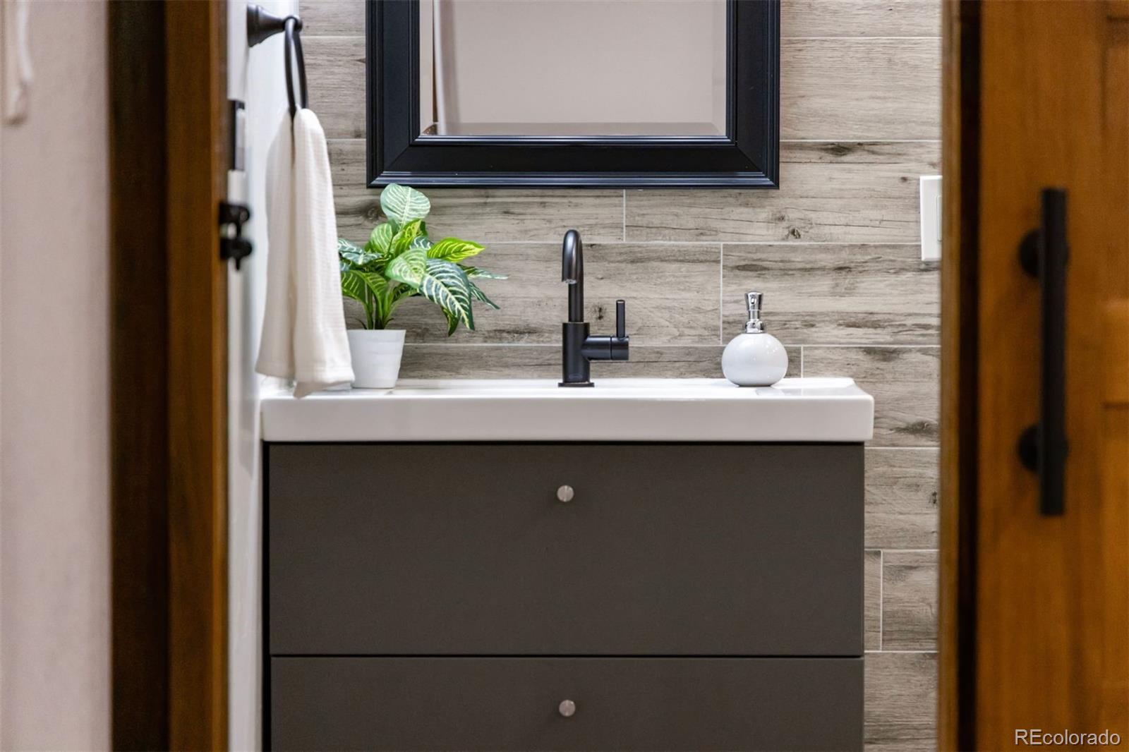 3692 South Mobile Way Aurora, CO 80013 - Photo 31 of 48 a bathroom with a sink and a mirror