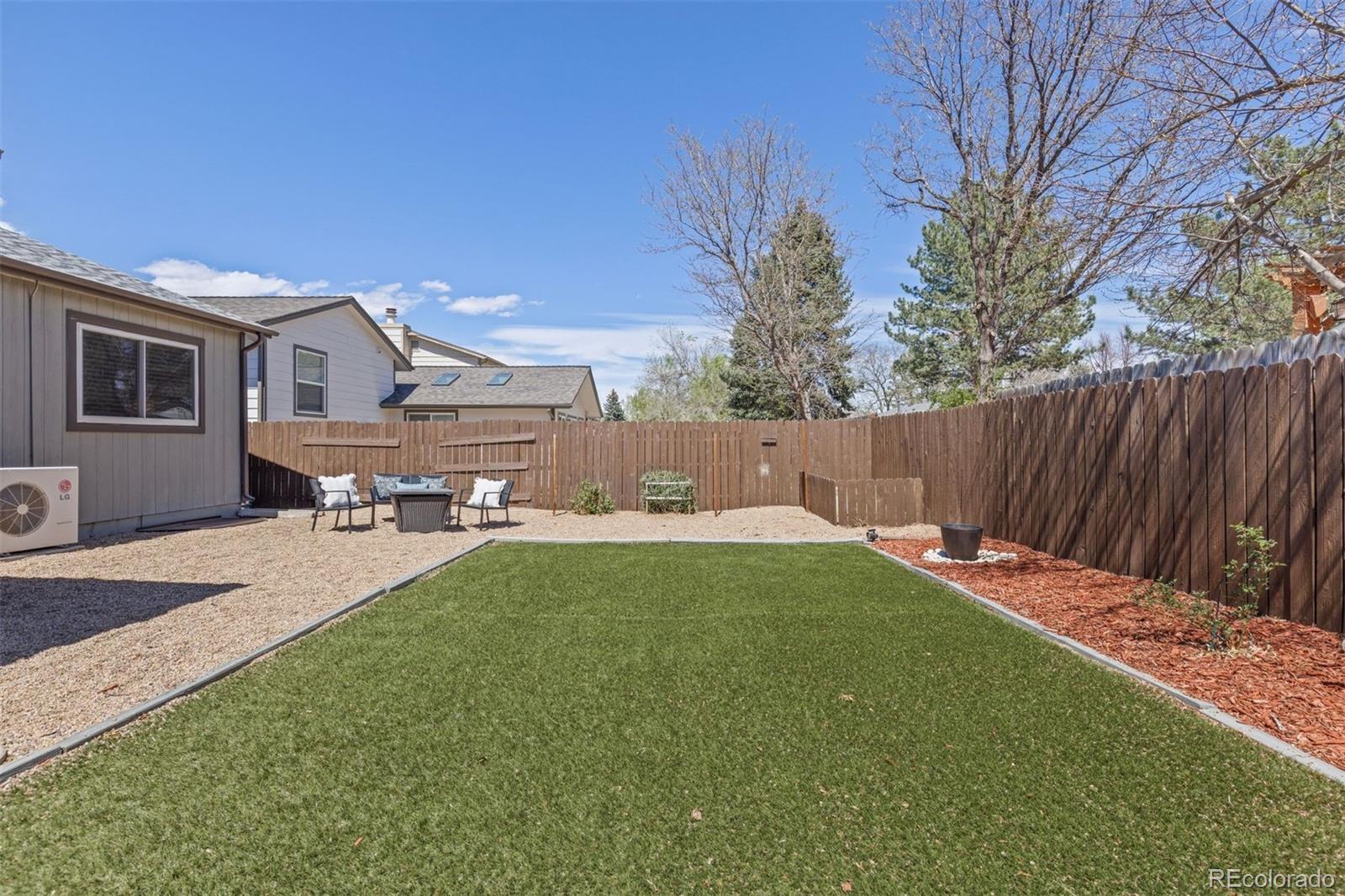 3692 South Mobile Way Aurora, CO 80013 - Photo 44 of 48 a backyard of a house with table and chairs