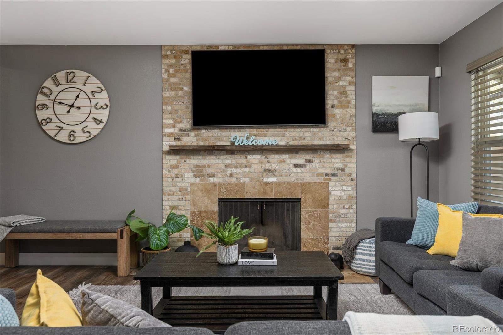 3692 South Mobile Way Aurora, CO 80013 - Photo 6 of 48 a living room with furniture fireplace and flat screen tv