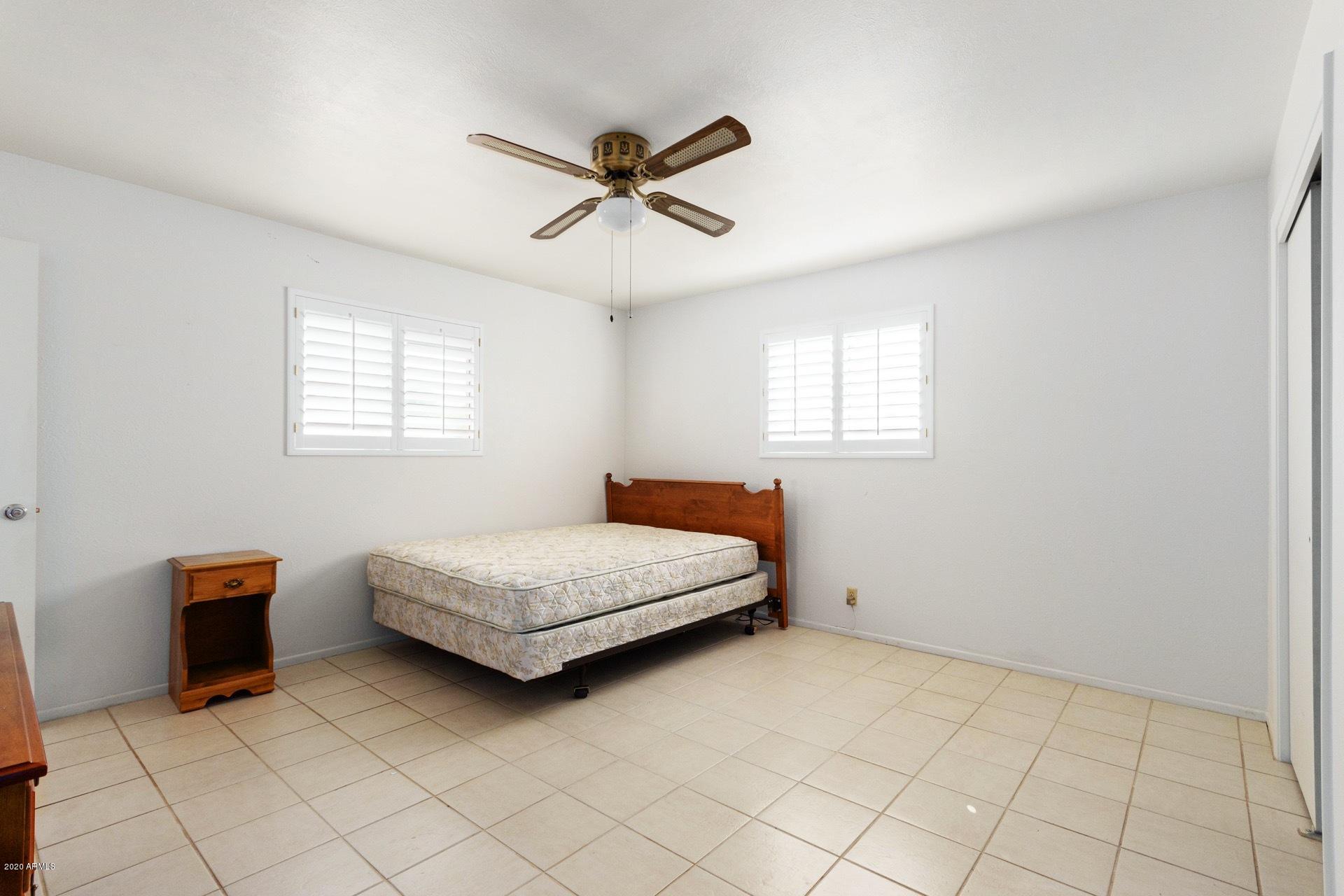 5704 East Decatur Street Mesa, AZ 85205 - Photo 31 of 40 a bedroom with a bed and window