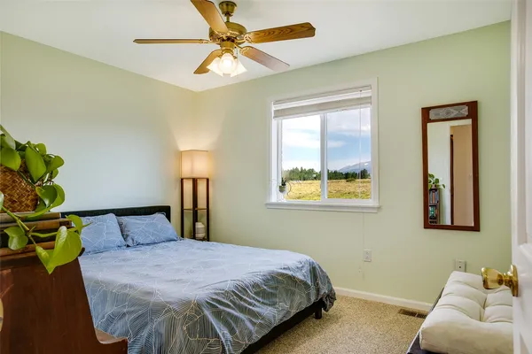 a bedroom with a bed and window