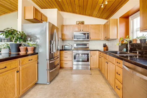 a kitchen with stainless steel appliances a sink and cabinets