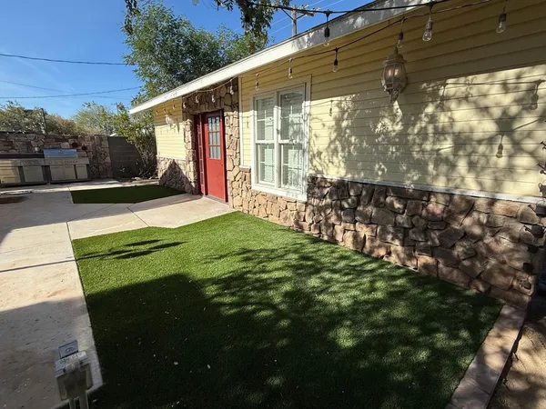 a view of a backyard with table and chairs and wooden fence