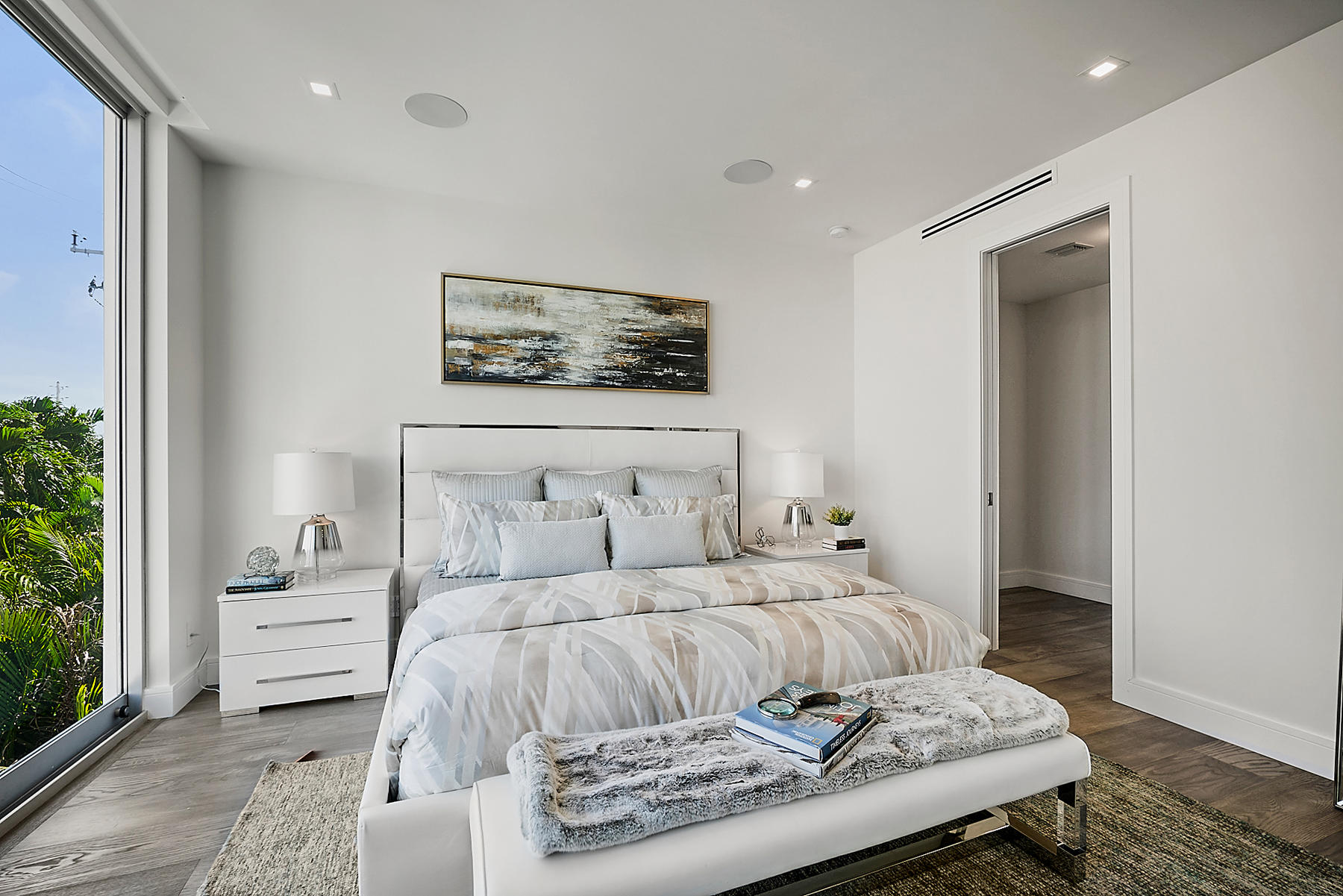 3092 Banyan Road, Unit A Boca Raton, FL 33432 - Photo 32 of 49 a bedroom with a bed and a night stand