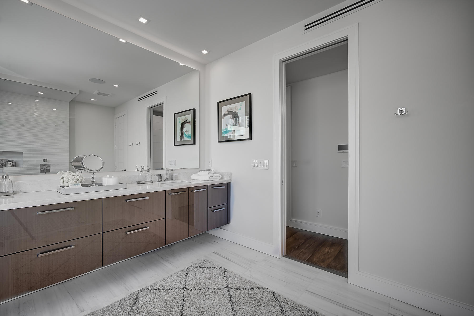 3092 Banyan Road, Unit A Boca Raton, FL 33432 - Photo 33 of 49 a bathroom with double vanity sink and mirror