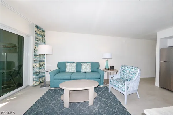 a living room with furniture and a toilet