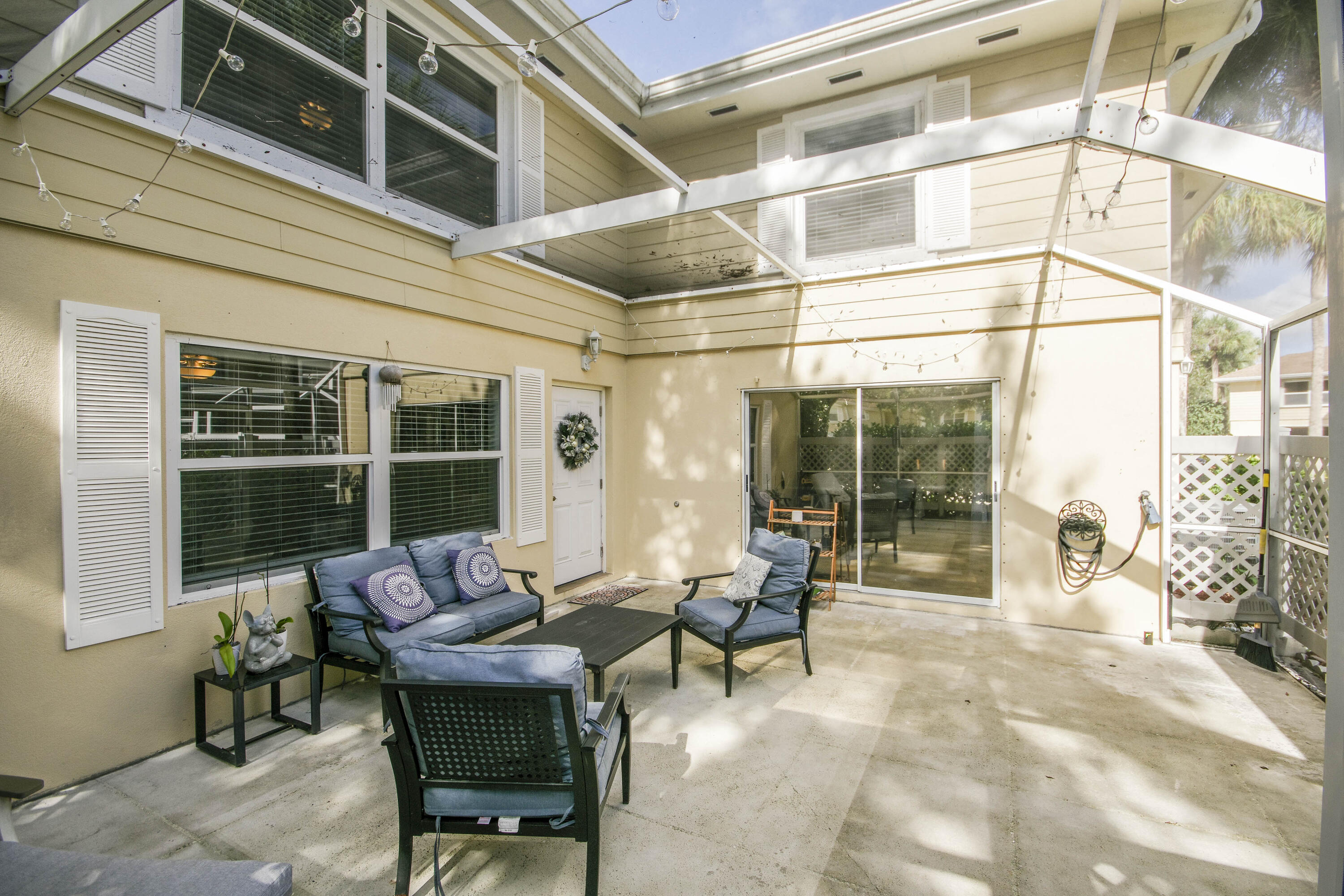 4603 Roxbury Court Boynton Beach, FL 33436 - Photo 4 of 19 a building outdoor space with patio furniture and potted plants