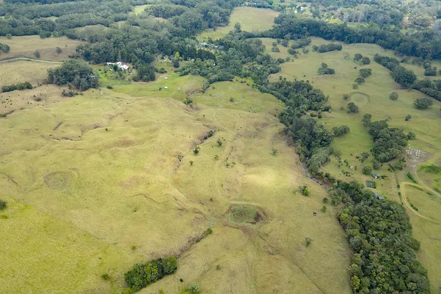 a view of a dry yard with mountains in the background
