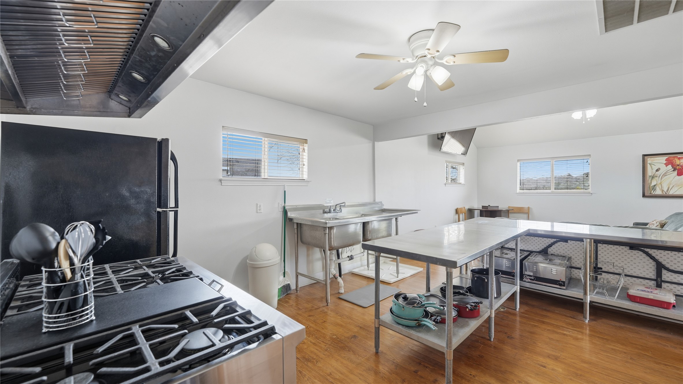 218 Little Ranch Road, Unit E Red Rock, TX 78662 - Photo 15 of 22 Kitchen featuring freestanding refrigerator, extractor fan, light wood finished floors, and a ceiling fan