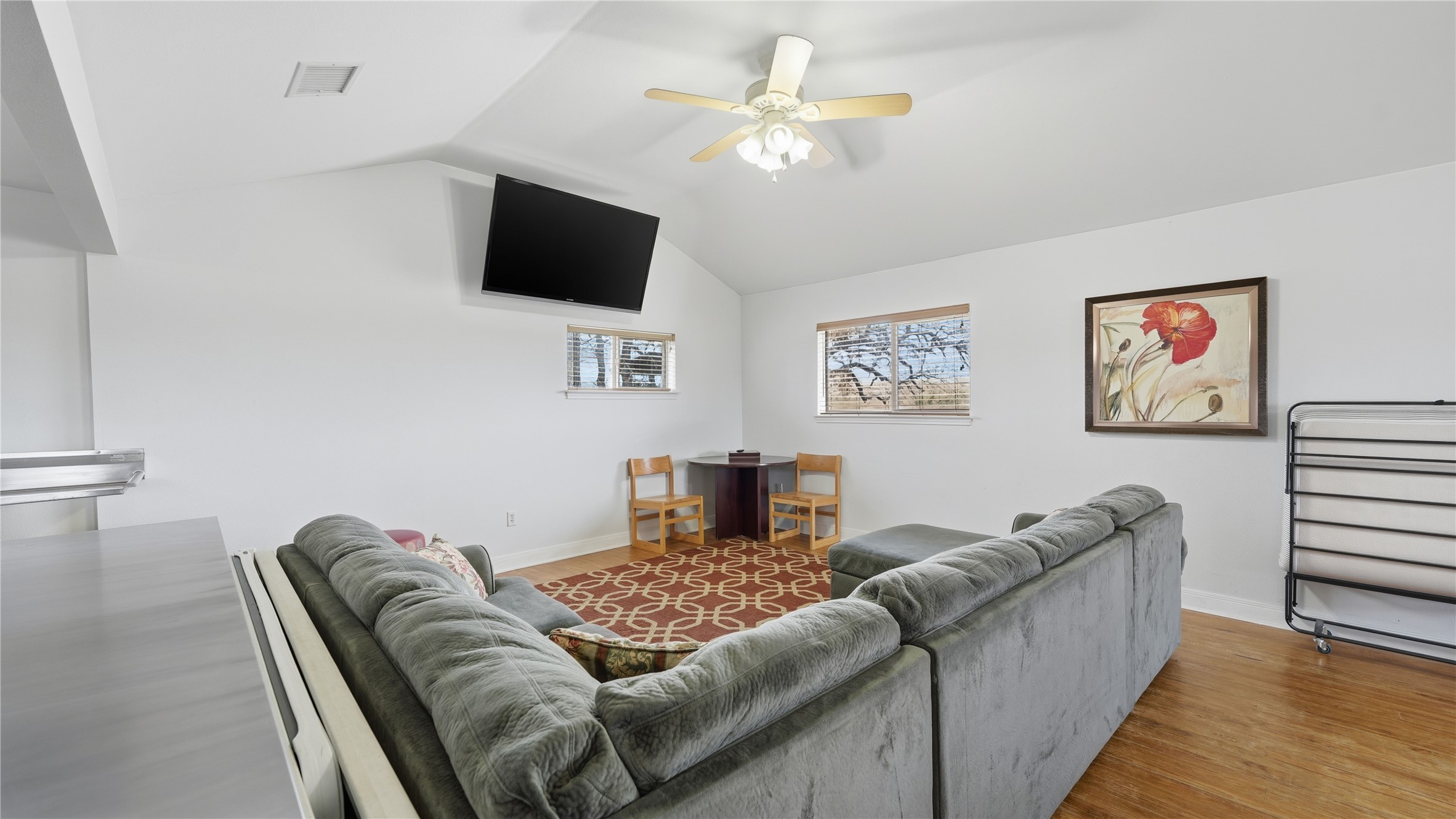 218 Little Ranch Road, Unit E Red Rock, TX 78662 - Photo 19 of 22 Living room featuring a ceiling fan, wood finished floors, and vaulted ceiling