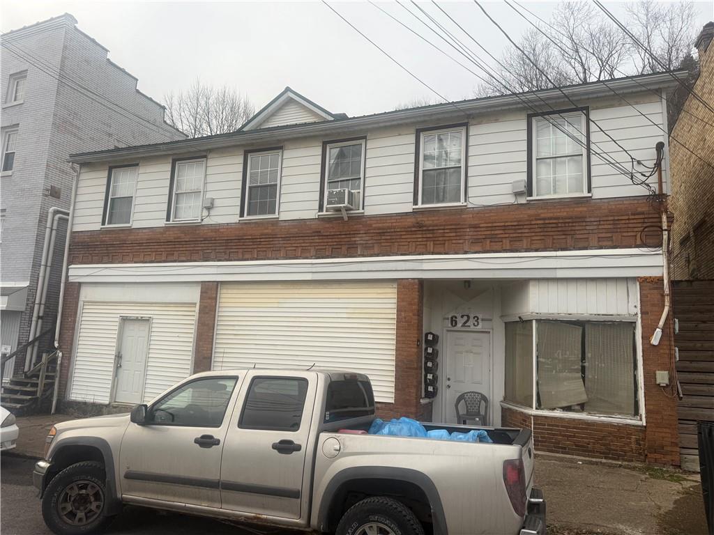 a front view of a house with parking space