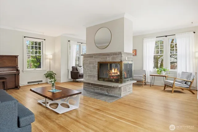 a living room with furniture a window and a fireplace
