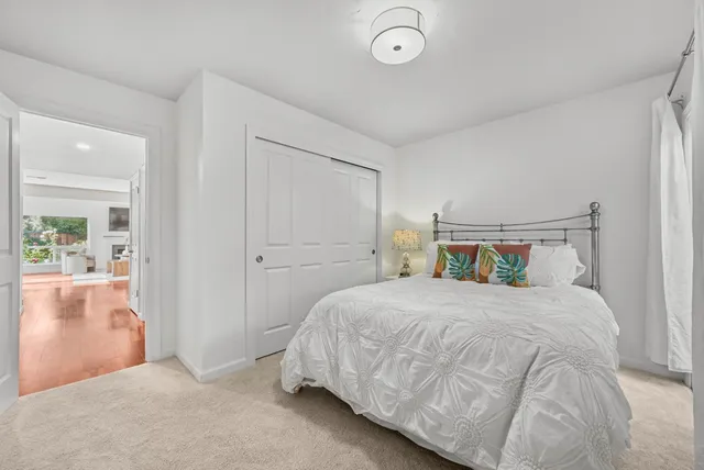 a bedroom with a bed and with a large mirror