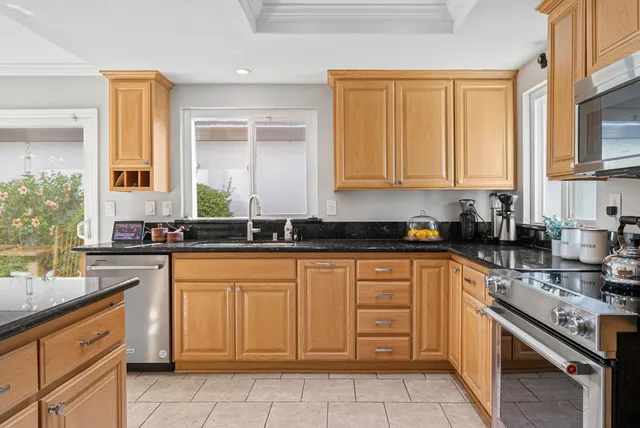 a kitchen with stainless steel appliances granite countertop a sink and cabinets
