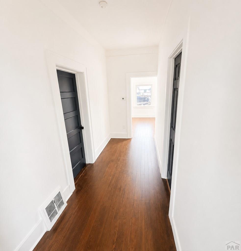 207 Spring Street Pueblo, CO 81003 - Photo 4 of 11 a view of a hallway with wooden floor