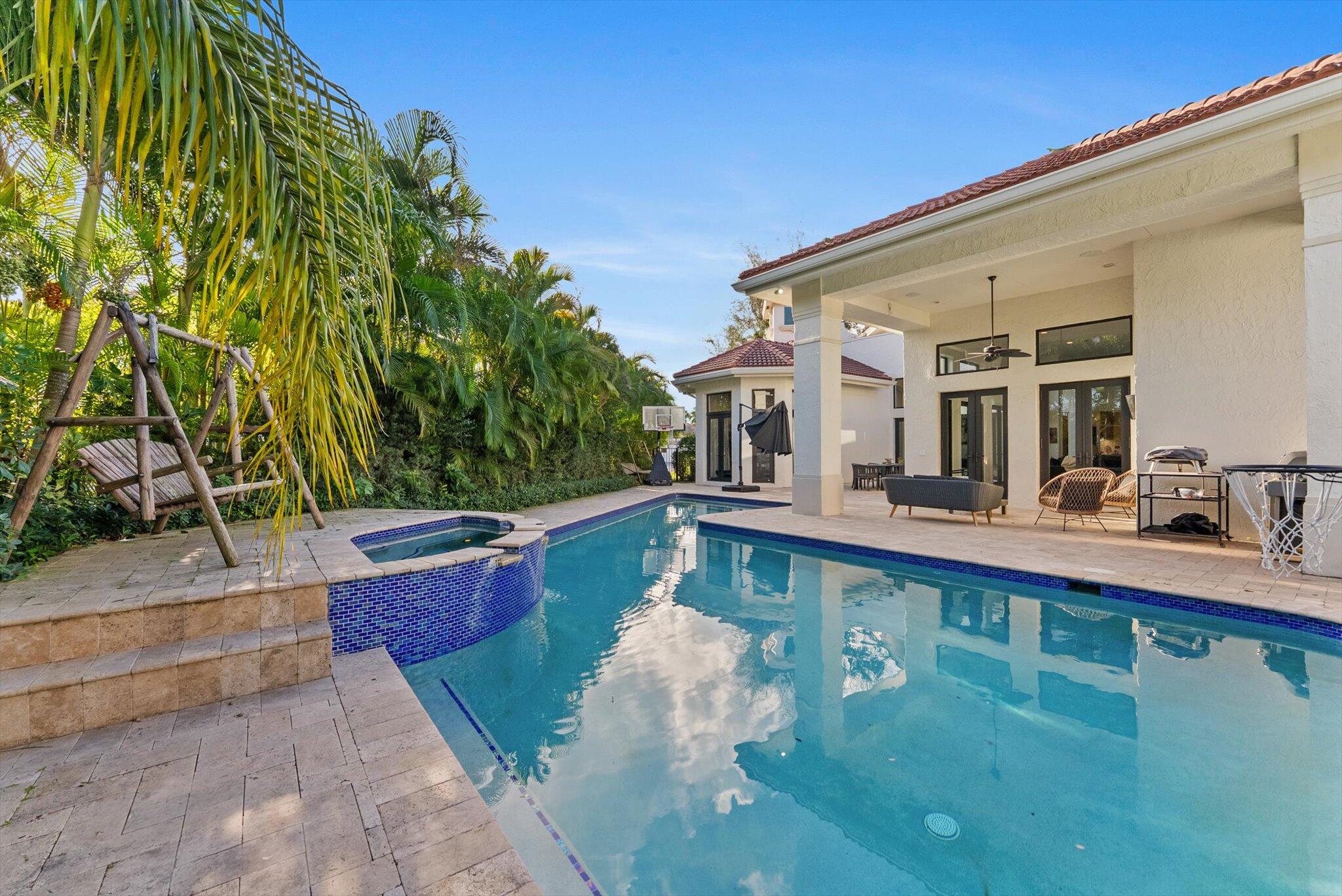 7955 Mandarin Drive Boca Raton, FL 33433 - Photo 55 of 74 a view of a swimming pool with two chairs