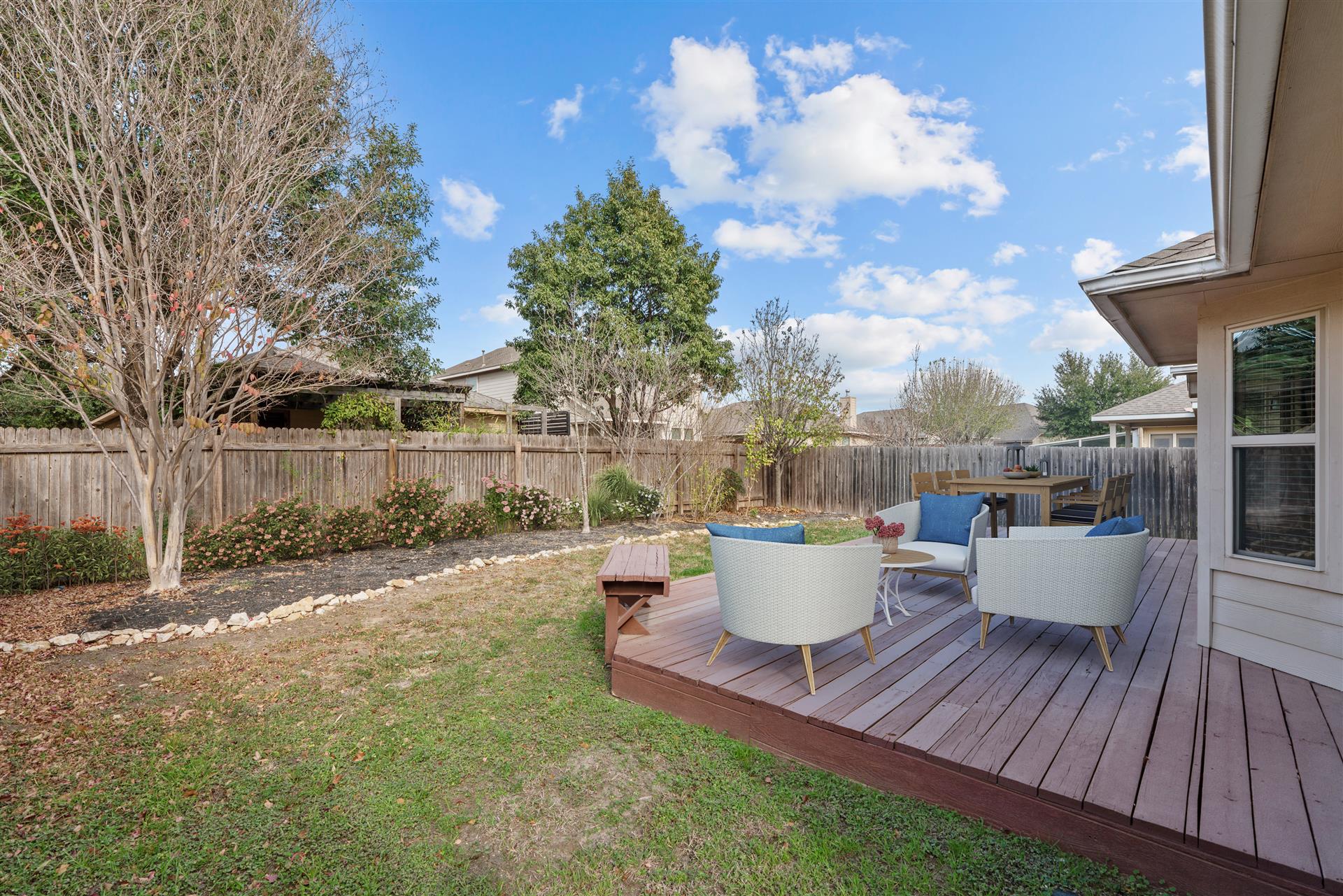 180 Fletcher Bend Buda, TX 78610 - Photo 5 of 36 a view of a white house with a yard and sitting area