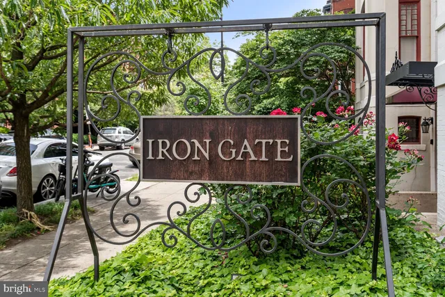 a view of sign board with lots of trees