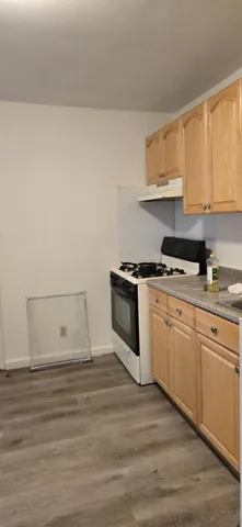 a kitchen with granite countertop white cabinets and white appliances