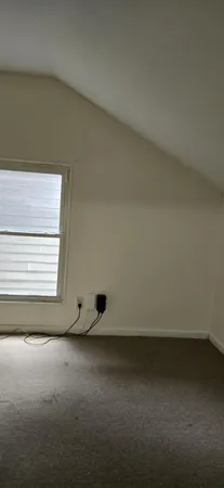 a view of an empty room and a window