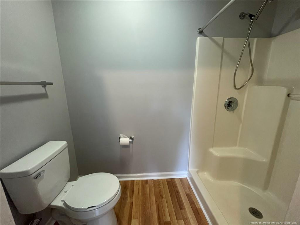 4219 Arbutus Drive, Unit A Raleigh, NC 27612 - Photo 14 of 30 a bathroom with a toilet and shower